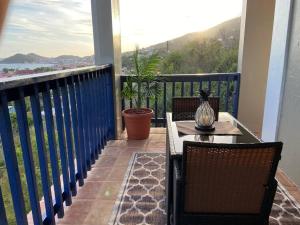 a balcony with a table and chairs on a balcony at Breathless Vista “4” in St Thomas