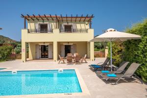 a villa with a swimming pool and a house at Armonia Villas in Lixouri