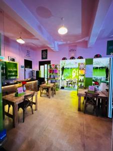 a restaurant with tables and chairs in a room at FRONTERA 49 Roma Norte Hostal in Mexico City