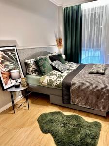 um quarto com uma cama e um tapete verde em Apartamenty Kielce- GREEN FOREST APARTAMENT, faktura, parking, centrum em Kielce