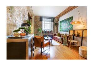 a kitchen and living room with a couch and a table at Suite4SerenityRWY in Plymouth +19 photos