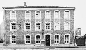 a black and white photo of a brick building at Hotel zur Brücke in Herzogenrath