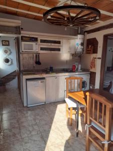 a kitchen with a wooden table and chairs and a table and a tablektop at Departamento Reconquista in Villa María
