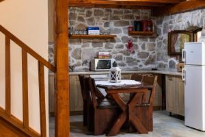 a kitchen with a wooden table and a refrigerator at House Wood in Orebić