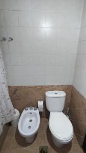 a bathroom with a toilet and a bidet at Loren House in Ciudad Lujan de Cuyo