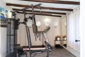 a room with a gym with a treadmill at House Wood in Orebić