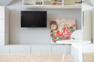 a tv on a white wall in a living room at Apartament Grójec in Grójec +1 photo