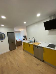 a kitchen with yellow cabinets and a counter top at VIAJERO in Briviesca
