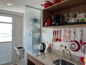 a kitchen with a sink and a counter with utensils at RIO STAY RESIDENCE in Rio de Janeiro