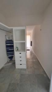 a white room with a white dresser and a hallway at Villas La Marina in Cancún