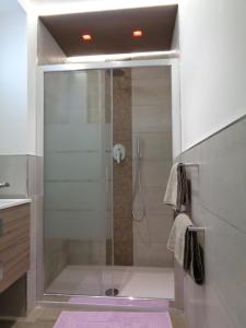 a shower with a glass door in a bathroom at Studio Le Marly in Menton