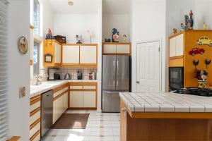 a kitchen with wooden cabinets and a stainless steel refrigerator at 1965 Benson in Cambria