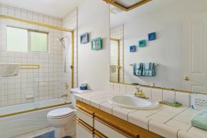 a bathroom with a sink and a toilet and a tub at 1965 Benson in Cambria +15 photos
