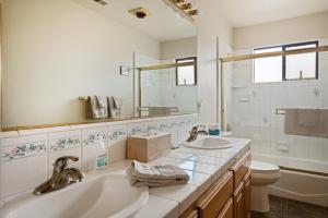 a bathroom with two sinks and a toilet and a mirror at 430 Orlando in Cambria +24 photos
