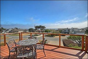 a patio with a table and chairs on a deck at 2116 Windsor Blvd. Marine Terrace in Cambria