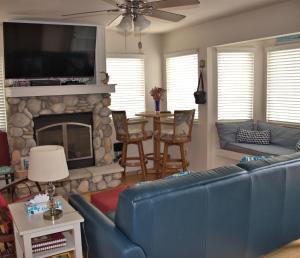 a living room with a blue couch and a fireplace at 2116 Windsor Blvd. Marine Terrace in Cambria
