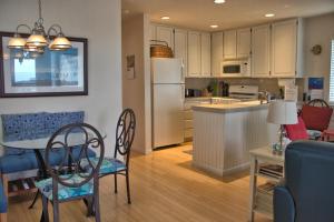 a kitchen and living room with a table and chairs at 2116 Windsor Blvd. Marine Terrace in Cambria +12 photos