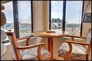 a table and two chairs in front of a window at 2116 Windsor Blvd. Marine Terrace in Cambria