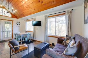 a living room with a couch and a table at Faith Cabin in Cosby Fire Pit and Covered Deck in Cosby