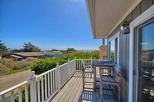 a balcony with a table and chairs on a house at 275 Stafford in Cambria