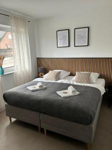 a bedroom with a large bed with two towels on it at HAMA Design Homes Paderborn 4 Apartments in Paderborn