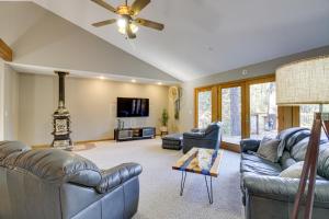 a living room with two couches and a tv at Peaceful Hibbing Getaway Heated Floors, Fire Pit! in Hibbing