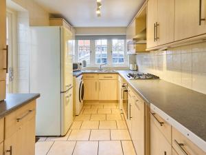 uma grande cozinha com armários brancos e uma bancada em Host & Stay - New Street em Canterbury