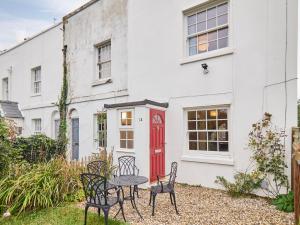 a table and chairs in front of a white building at Host & Stay - New Street in Canterbury