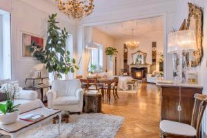 a living room with white furniture and a fireplace at Villa Aida in Milan