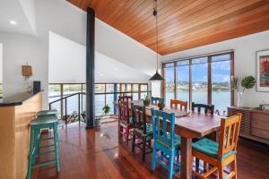 a kitchen and dining room with a wooden table and chairs at Riverview in Warrnambool