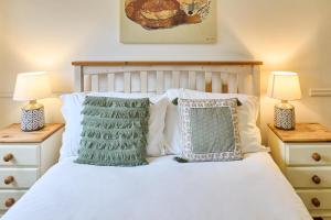 a bedroom with a white bed with two lamps at Host & Stay - The Cabin in Canterbury