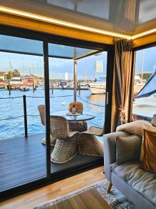 a living room with a view of the water at Hausboot AHOY Masal in Lübeck