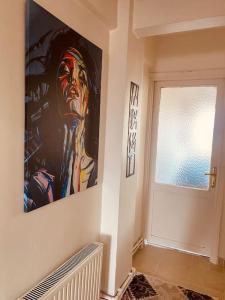 a painting of a man on a wall next to a door at Sea View Apartment in Kadikoy in Istanbul