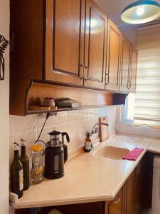 a kitchen counter with a coffee maker and a sink at Sea View Apartment in Kadikoy in Istanbul