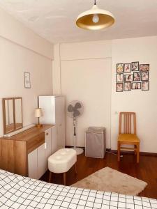 a bedroom with a refrigerator and a desk and a chair at Sea View Apartment in Kadikoy in Istanbul
