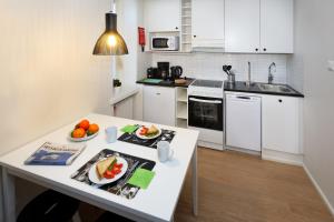 a kitchen with a table with fruit on it at Forenom Serviced Apartments Helsinki Kruununhaka in Helsinki