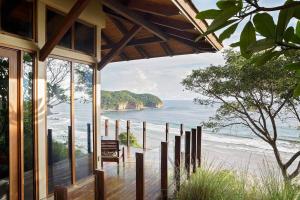 a beach house with a view of the ocean at Mukul Resort in Tola
