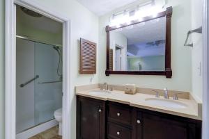 a bathroom with a sink and a shower and a mirror at 62 Port Tack, Hilton Head Island, SC, 29928 in Hilton Head Island +38 photos
