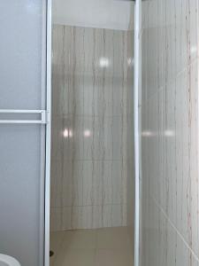 a shower with a glass door in a bathroom at CABAÑA MANZUREN in Arboletes
