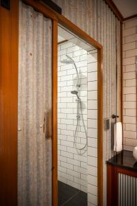 a shower in a bathroom with a shower curtain at Angaston Saleyards Luxury Accommodation in Angaston