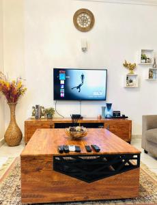 a living room with a tv and a coffee table at Exotic 2 BR Apartment at Wuye, Abuja - Wifi,Netflix in Abuja
