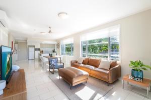 a living room with a couch and a table at 30 Airlie Beach Bliss at The Summit in Airlie Beach