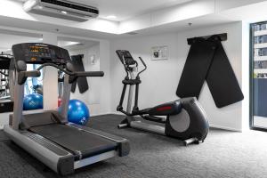 a gym with a treadmill and a exercise bike at Oaks Brisbane on Felix Suites in Brisbane
