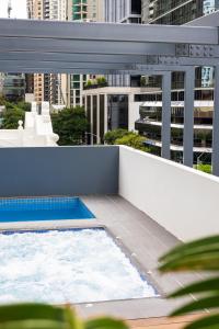 a balcony with a swimming pool on top of a building at Oaks Brisbane on Felix Suites in Brisbane