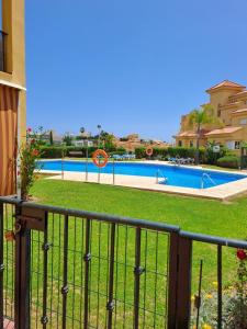 a balcony of a house with a swimming pool at Bienvenido a tu habitacion in Málaga