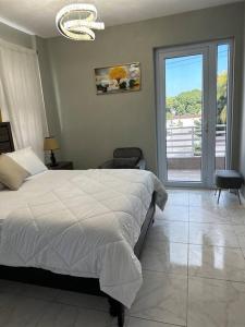 a bedroom with a bed and a large window at BYRD’S Oasis Apartment in Kingston