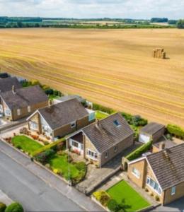 an aerial view of a house with a field at Shirley's Place in Boston Spa