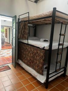 two bunk beds in a room with a doorway at CASA DE LOURDES - LA CANDELARIA in Bogotá