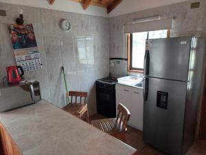 a kitchen with a stainless steel refrigerator and a stove at Cancel in Pucón