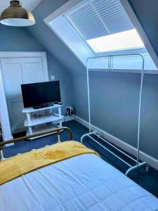 a bedroom with a bunk bed and a tv at GWR Dickson's B&B in Wick